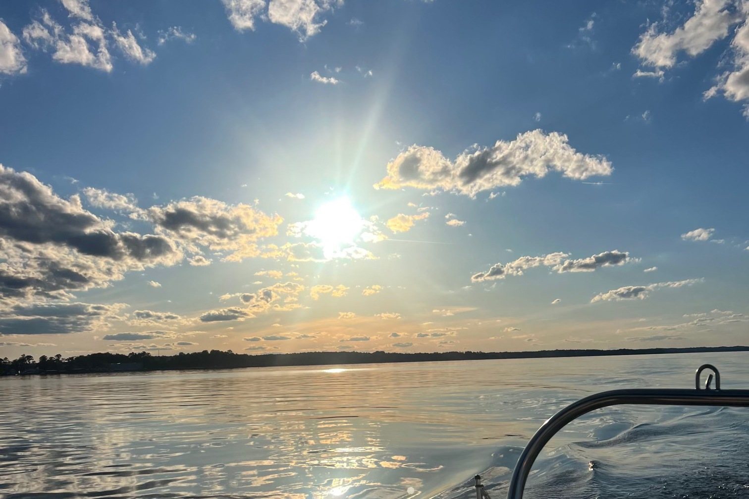 Sunset over Lake Martin from the back of a boat